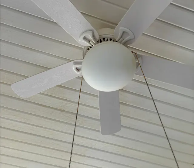 After: The same ceiling fan and ceiling, white.